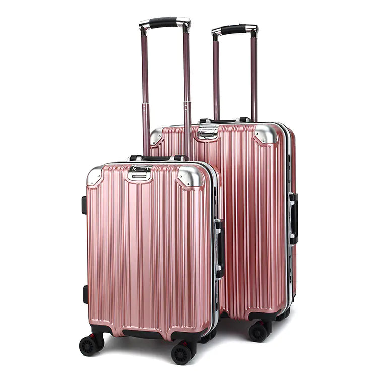 Two rose gold suitcases with black handles and wheels on a white background