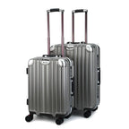 Two dark grey suitcases with wheels on a white background