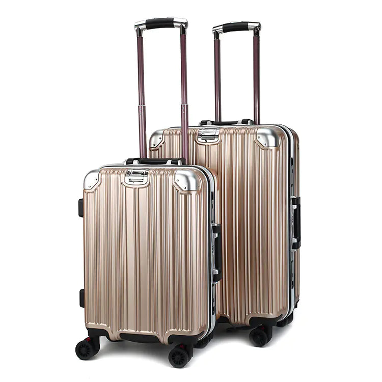 Two metallic beige suitcases with wheels on a white background