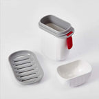 Set of three gray and white soap containers on a white background