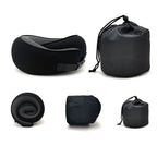 Black travel pillow and accessories on a white background