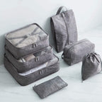 Set of gray packing cubes and bags on a light background