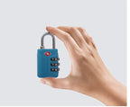 Hand holding a blue combination lock against a light gray background