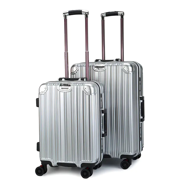 Two silver suitcases with black handles and wheels on a white background