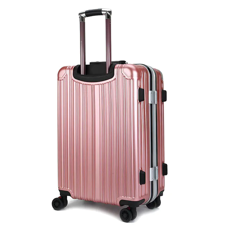 Rose gold suitcase with black wheels on a white background